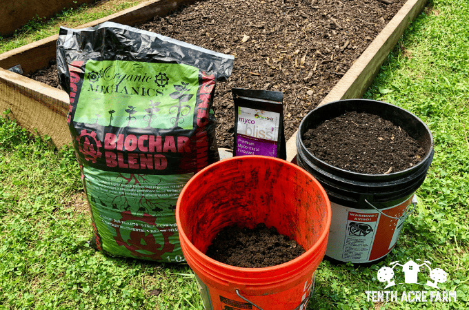 Buckets and bags of amendments showing Amy's preferred supplies for nurturing living soil.